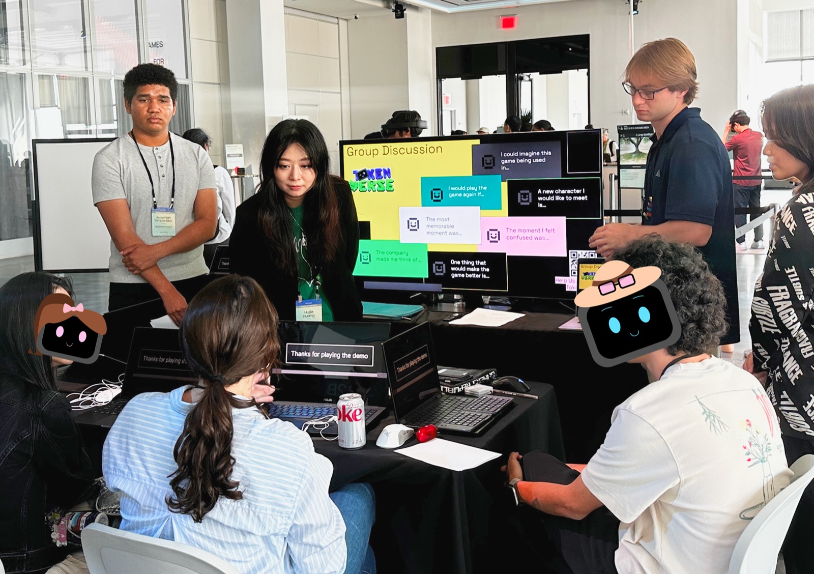 The team reviewing group discussion feedback on a shared screen at the Games for Change booth